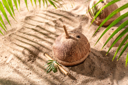 Refreshing and delicious coconut milk in shell for hot days. Drink served on an exotic beach.の写真素材