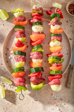 Preparations for grilling tasty skewers with vegetables and red beef Grilled shashlik with fresh ingredients.の写真素材