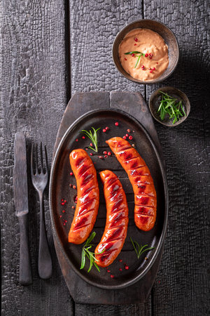 Delicious grilled sausage made on a metal grill. Grilled sausage seasoning with rosemary and lime.の写真素材