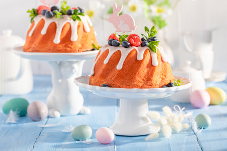 Delicious Easter ring cake with flower and painted eggs. Easter cake with fruits.の写真素材