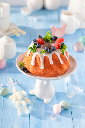 Homemade ring cake for Easter as sweet Easter pastry. Cake, Easter eggs and flowers for Easter.の写真素材