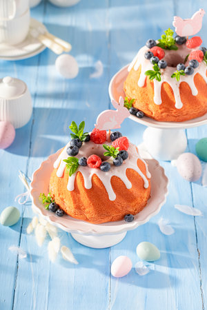 Closeup of Easter ring cake as classic Easter dessert. Easter spring background with flowers and easter eggs.の写真素材