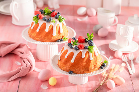 Tasty ring cake for Easter on holiday table with decorations. Bundt cake as Babka for Easter.の写真素材