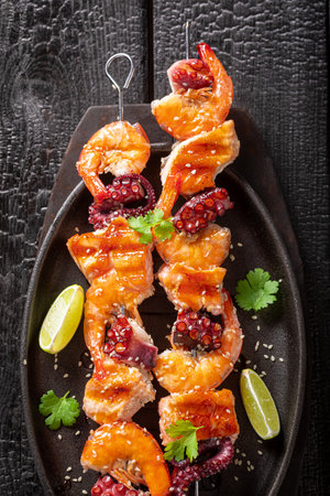 Spicy grilled skewer as a healthy summer appetizer. Summer grilled shashlik with fish.の写真素材