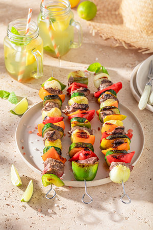 Tasty roasted skewer served with lime and herbs. Roasted shashlik seasoning with spices.の写真素材