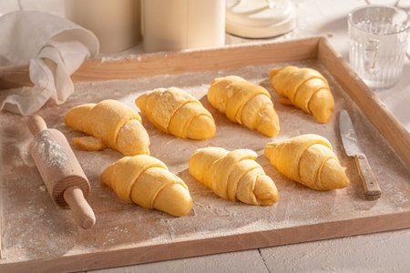 Sweet french croissants made of raw puff pastry. Raw croissants before baking.の写真素材