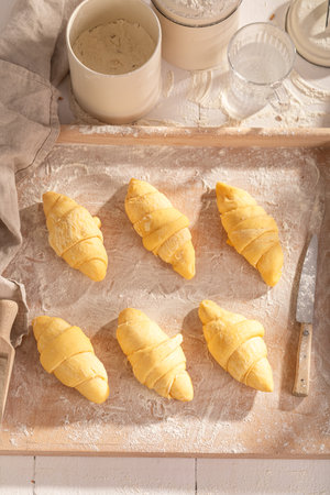 Delicious french croissants preparation before baking in oven. Raw croissants before baking.の写真素材