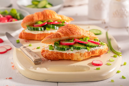 Tasty and hot french croissant as a sandwich for vegans. Croissants with spring and healthy ingredients.の写真素材