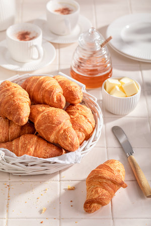 Crunchy and tasty french croissants as a popular snack. Breakfast with coffee, honey and butter.の写真素材