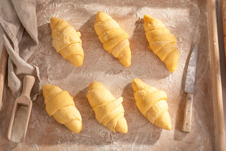 Sweet french croissants preparation for baking in home. Raw croissants before baking.の写真素材