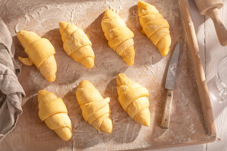 Sweet french croissants preparation before baking in oven. Preparing croissants at home.の写真素材