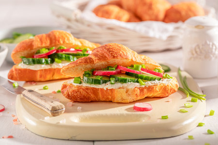 Tasty and hot french croissant in spring morning. Croissants as fresh sandwich with vegetables.の写真素材