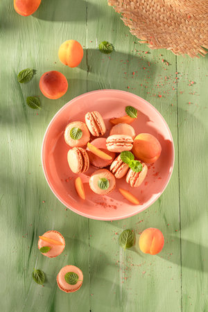 Fresh and delicious peach macarons made of orange fruits. Sweet macarons made of apricots.の写真素材