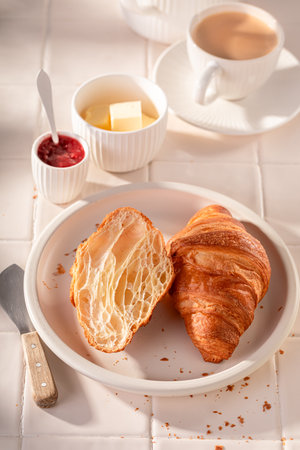 Hot and tasty french croissants for breakfast. Breakfast with butter and jam.の写真素材