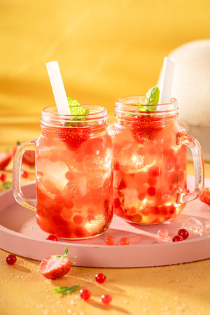 Sweet strawberry bubble tea with berry fruits, balls on ice. Chilled drink for hot days.の写真素材