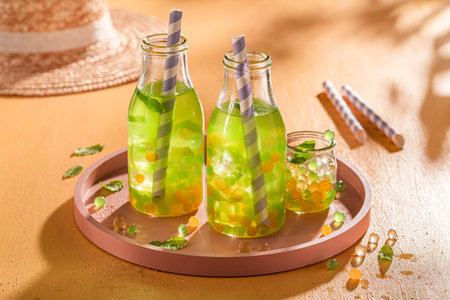 Fresh bubble tea with green and yellow balls with ice. Bubble tea with fresh jelly.の写真素材