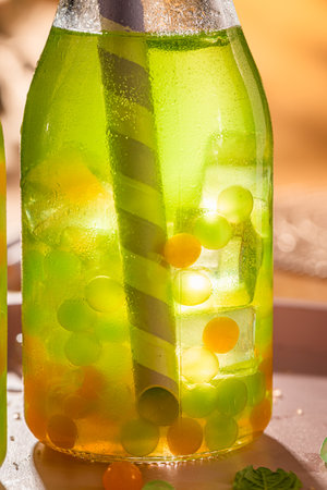 Homemade bubble tea with green and yellow balls with ice. Bubble tea with fresh jelly.の写真素材