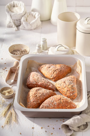 Healthy and hot triangular rolls baked in a bakehouse. Triangular rolls and ingredients in the...