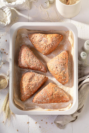 Tasty and homemade triangular buns for perfect and healthy breakfast. Triangular rolls and ingredients in the bakery.の写真素材