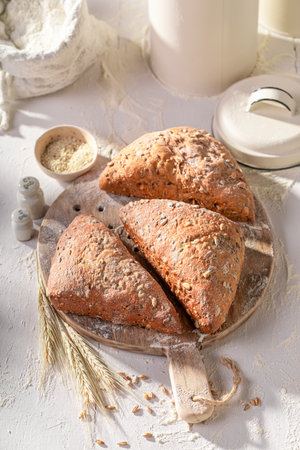 Tasty and brown triangular rolls freshly baked in home bakery. Triangular buns baked in a bakery.の写真素材