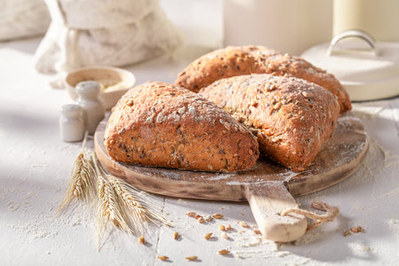 Healthy and hot triangular buns baked in the bakery. Triangular rolls and ingredients in the bakery.