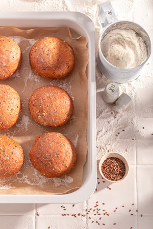 Homemade and healthy flax seed buns in rustic bakehouse. Flax seed buns baked in a bakery.の写真素材