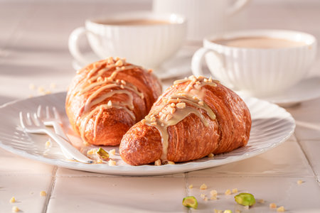 Homemade and sweet pistachio croissants with nut filling. Traditional snack in France.の写真素材