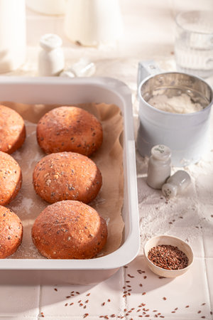 Homemade and healthy flax seed buns freshly baked in bakery. Flax seed rolls and ingredients in the bakery.の写真素材