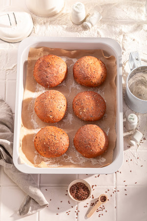 Hot and brown flax seed buns in rustic bakehouse. Flax seed buns baked in a bakery.の写真素材