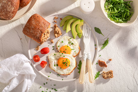 Tasty and american breakfast with buns and fried eggs. British breakfast.の写真素材