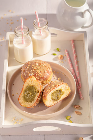 Homemade and sweet pistachio donuts for Fat Thursday. Served with milk. Most popular dessert.の写真素材