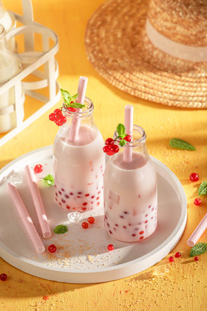 Cold and healthy red currant bubble tea full of vitamins. Summer milky drink.の写真素材