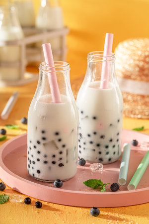 Sweet blueberry bubble tea made of kefir and forest fruits. Chilled drink for hot days.の写真素材