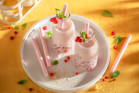 Delicious and homemade red currant bubble tea with milkshake and ice. Summer milky drink.の写真素材