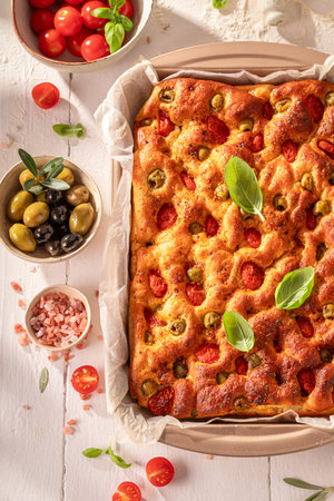 Tasty focaccia with cherry tomatoes and olive oil. Poster for Restaurant. Focaccia made of fresh ingredients.の写真素材