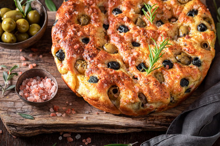 Traditional focaccia with olive oil and olives. Classic Italian cuisine. Focaccia with olives.の写真素材