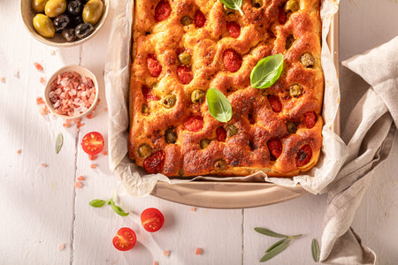 Tasty focaccia with green olives and cherry tomatoes. Classic Italian cuisine. Focaccia made of fresh ingredients.の写真素材