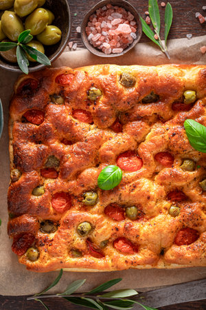 Tasty focaccia with olives and cherry tomatoes. Traditional focaccia. Focaccia made of fresh ingredients.の写真素材