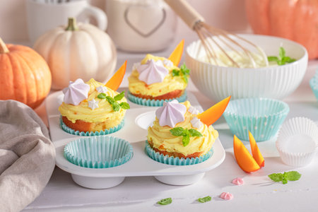 Homemade pumpkin muffins baked and decorated for Halloween. Dessert for the Halloween.の写真素材