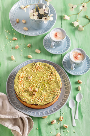 Tasty pistachio cheesecake bake in home kitchen. Pistachio cheesecake with nuts glazed.の写真素材
