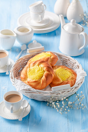 Fresh and homemade cheese yeast bun as summer dessert with coffee.. Yeast cake with coffee.