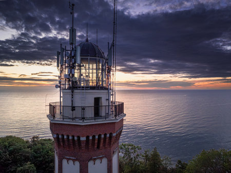 Unique lighthouse on the Baltic Sea at sunset in Poland. Vacation at the seaside.の写真素材