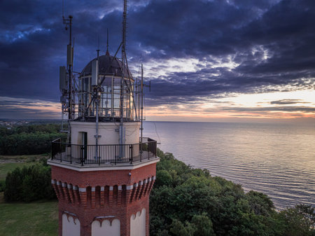 Unique sea and lighthouse at sunset in Poland. Tourism at the Sea.の写真素材