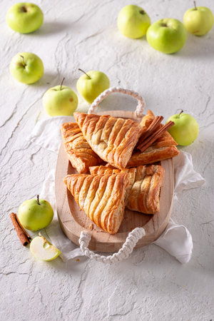 Delicious apple triangle cake served in sunny kitchen. Cake made of green apples.の写真素材