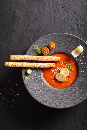 Exquisite tomato soup as a fine dish in a restaurant. Tomato soup with an exquisite decoration.の写真素材