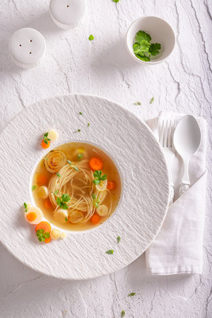 Elegant broth soup as elegant and tasteful fine dish. Broth soup with an exquisite decoration.の写真素材