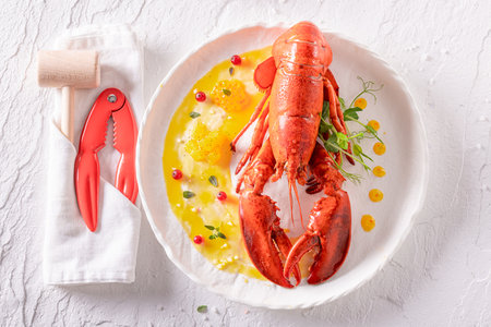 Professional boiled lobster as a fine dish in a restaurant. Lobster seasoning with orange and butter.の写真素材