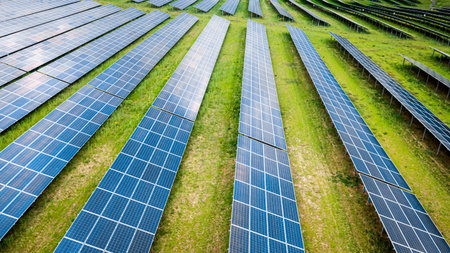 Big and blue photovoltaic farm as a renewable energy source. Pure energy in the countryside.