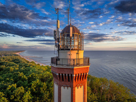 Unique coast and the lighthouse at sunset in Poland. Vacation at the seaside.の写真素材