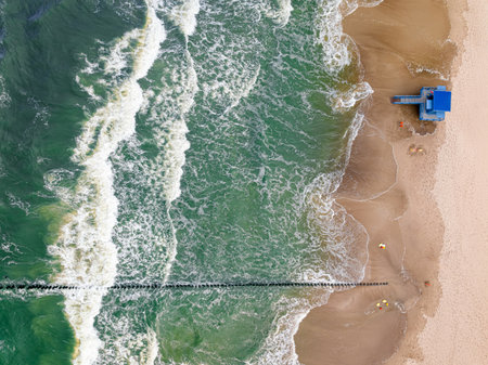 Lifeguard tower flooded by big waves at Baltic Sea, Poland. Aerial view of Baltic sea after storm.の写真素材